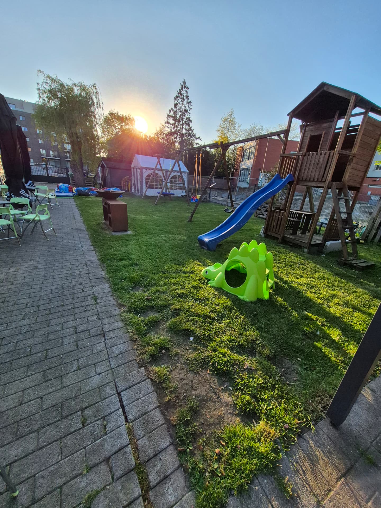 De speeltuin en tuin in de avondzon